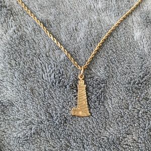 Gold rope necklace with light house charm